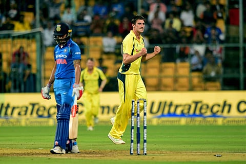Australia's Pat Cummins celebrates the wicket of India's Manish Pandey during the fourth ODI match between India and Australia at Chinnaswamy Stadium in Bengaluru on Thursday. | PTI