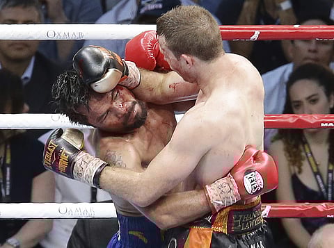 Manny Pacquiao of the Philippines, left, clinches with Jeff Horn of Australia, during their WBO World Welterweight title fight. (AP Photo/Tertius Pickard)