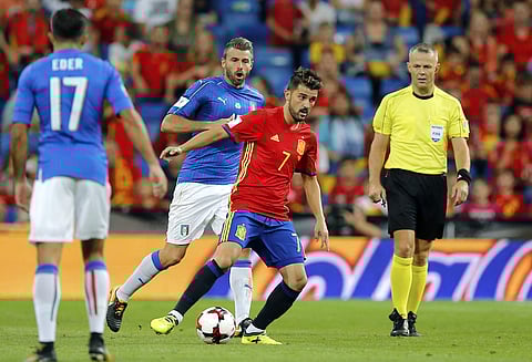 Spain's David Villa, center right, controls the ball during the World Cup Group G qualifying soccer match between Spain and Italy. | AP