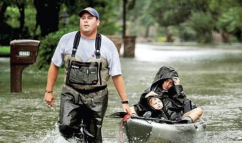 People being evacuated on a boat from a flooded Houston locality after Hurricane Harvey inundated the US city (File| PTI)