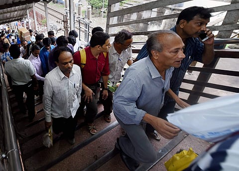 Commuters at the Elphinstone railway station's foot over bridge where a stampede took place in Mumbai on Friday. | PTI