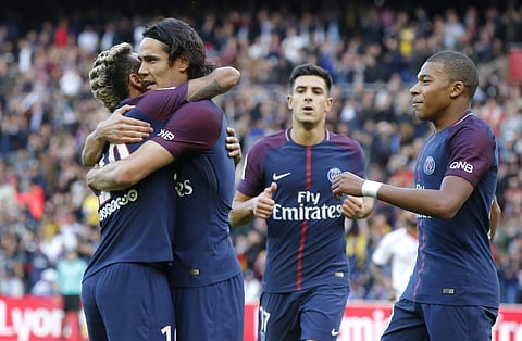 PSG's Neymar, left, congratulates Edison Cavani , center, for his second gaol as Lucas Mbappe looks on during a French League One soccer match Paris-Saint-Germain against Bordeaux at Parc des Princes stadium in Paris. | AP