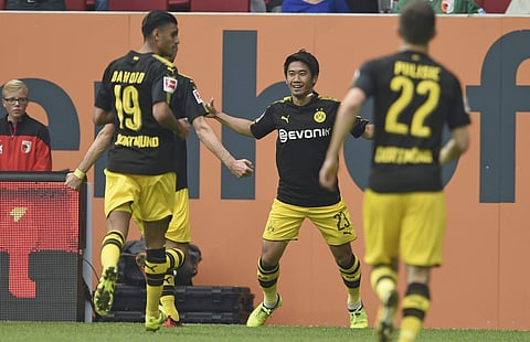 Dortmund's Shinji Kagawa, center, celebrates a goal during the German Bundesliga match between FC Augsburg and Borussia Dortmund in Augsburg, Germany, Saturday. | AP
