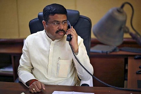 India's Oil Minister Dharmendra Pradhan speaks on phone during an interview with Reuters in New Delhi in 2016. (File Photo | Reuters)