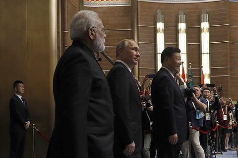 Chinese President Xi Jinping, right, walks with Russian President Vladimir Putin, second from right, and Indian Prime Minister Narendra Modi for a plenary session of BRICS Summit. | AP