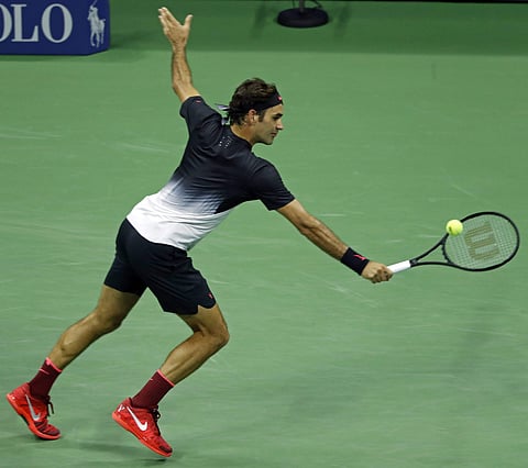 Roger Federer, of Switzerland, returns a shot against Philipp Kohlschreiber, of Germany, during the fourth round of the U.S. Open tennis tournament. | AP
