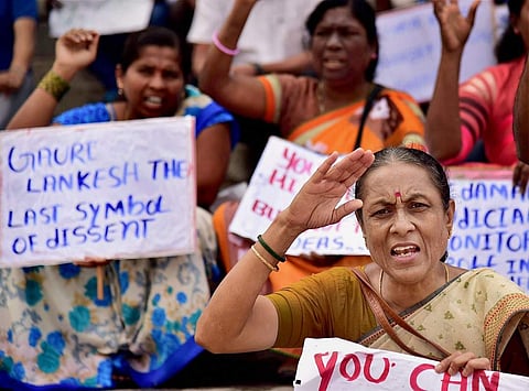 Bengaluru Citizens with posters and placards during a protest against the killing of journalist Gauri Lankesh who was shot dead by motorcycle-borne assailants outside her residence last night during a protest in Bengaluru on Wednesday. | PTI