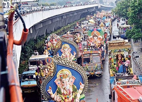 As devotees headed towards the Hussainsagar lake to immerse Ganesh idols, traffic in the city, also hit by a downpour, was affected leaving commuters stuck on the roads for hours | Vinay Madapu