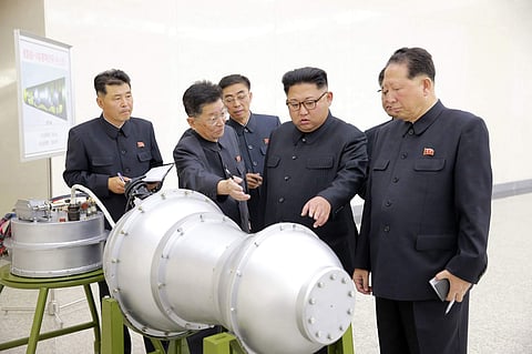 North Korea’s state media said leader Kim Jong Un, centre, inspected the loading of a hydrogen bomb into a new intercontinental ballistic missile. | AP