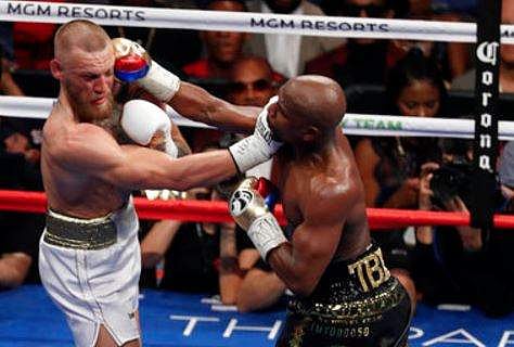 Floyd Mayweather Jr. hits Conor McGregor in a super welterweight boxing match in Las Vegas. | AP