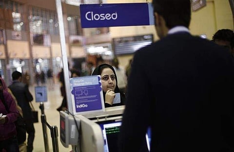A passenger stands at an Indigo Airlines' counter as she waits to get her boarding pass at the Srinagar airport . REUTERS/Adnan Abidi/Files