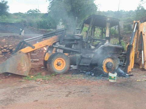 A torched JCB at Visakhapatnam Agency in Andhra Pradesh. (EPS)