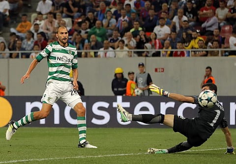 Sporting's Bas Dost, left, scoring his goal during the Champions League soccer match between FC Steaua Bucharest and Sporting CP at the National Arena, in Bucharest. | AP