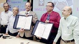 IIPE director VSRK Prasad and Texas A&M University professor Debjyoti Banerjee exchange MoU papers at Andhra University on Tuesday | Express