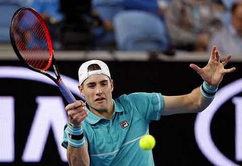 United States' John Isner makes a forehand return to Australia's Matthew Eden during their first round match at the Australian Open tennis championships in Melbourne | Photo: AP