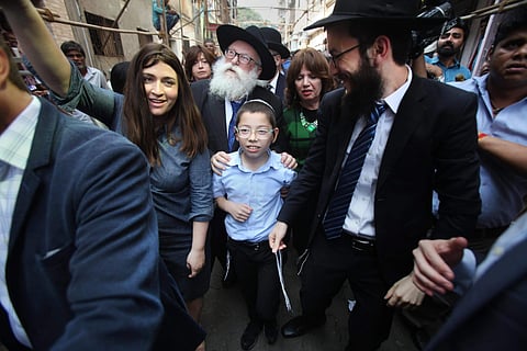 Israeli boy Moshe Holtzberg who lost his parents during the 26/11 Mumbai terror attacks arrives at Nariman House in Colaba in Mumbai on Tuesday. (PTI)