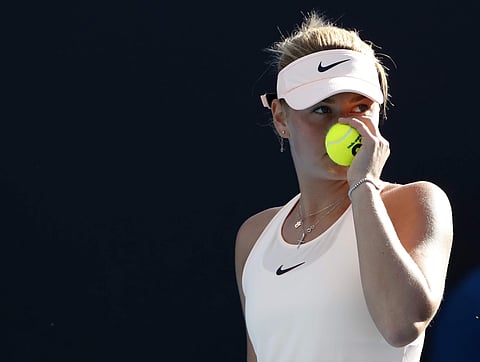 Ukraine's Marta Kostyuk holds a ball while playing China's Peng Shuai | AP