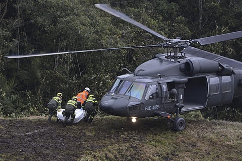 Rescue workers place the body of an airplane crash victim into a waiting helicopter, in La Union, near Medellin, Colombia. (File | AP)