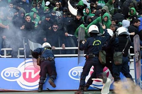 Panathinaikos' fans clash with members of the riot police prior to the Greek Cup final football match between PAOK Saloniki and Panathinaikos Athens at the Athens Olympic Stadium | Photo: AFP