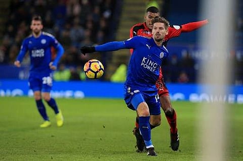 Leicester City's Portuguese midfielder Adrien Silva (front) vies with Huddersfield Town's German striker Collin Quaner during the English Premier League football match between Leicester City and Huddersfield Town at King Power Stadium in Leicester, centra