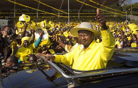 FILE - In this Tuesday, Feb. 16, 2016 file photo, Uganda's long-time President Yoweri Museveni waves to supporters from the sunroof of his vehicle as he arrives for an election rally at Kololo Airstrip in Kampala, Uganda. | AP