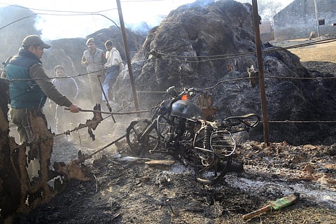 A police personnel inspects a temporary shed of a nomadic Gujjar damaged in the cross-border shelling by Pakistan at Jora Farm village in Jammu on Saturday. | PTI