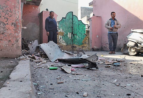 Locals assess the damage caused due to the cross-border shelling by Pakistan at the international border at Kanachak village in Jammu on Saturday. PTI Photo