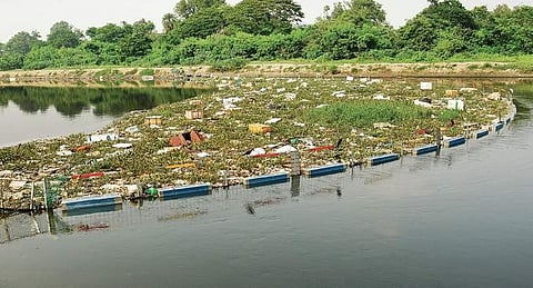 Trash boom, a aluminium fence like barrier, installed on  the Cooum River  | d sAMPATH KUMAR