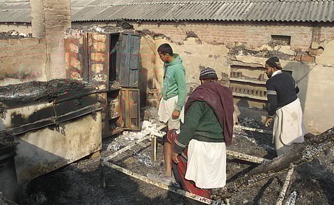 Villagers looking at their damaged house after heavy shelling by Pakistani forces at border village Jora Farm in R S Pura Sector. | PTI