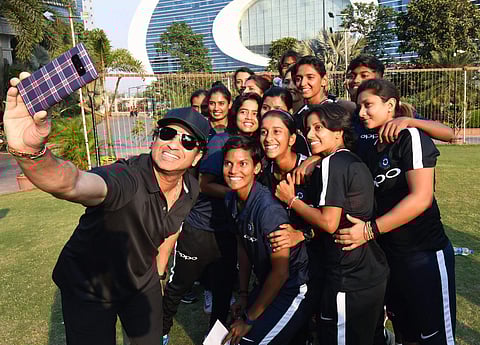 Former cricketer Sachin Tendulkar takes a selfie with members of the Indian Women's Cricket team at MCA BKC in Mumbai on Monday. The team will be travelling to South Africa for a T20 and ODI matches. | PTI