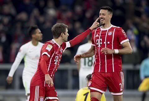 Munich's Thomas Mueller celebrates with Sandro Wagner after scoring during the German first division Bundesliga soccer match between Bayern Munich and Werder Bremen in the Allianz Arena in Munich. | AP