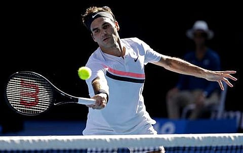 Switzerland's Roger Federer makes a forehand return to Hungary's Marton Fucsovics during their fourth round match at the Australian Open tennis championships in Melbourne. | Photo: AP
