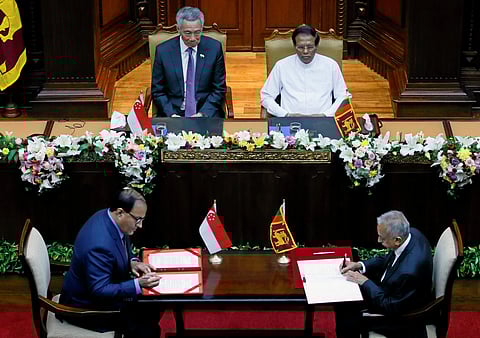 Singapore Minister for Trade and Industry Iswaran signs the bilateral free trade agreement with Sri Lanka's Minister of Development Strategies and International Trade Samarawickrama in Colombo. (Reuters Photo)