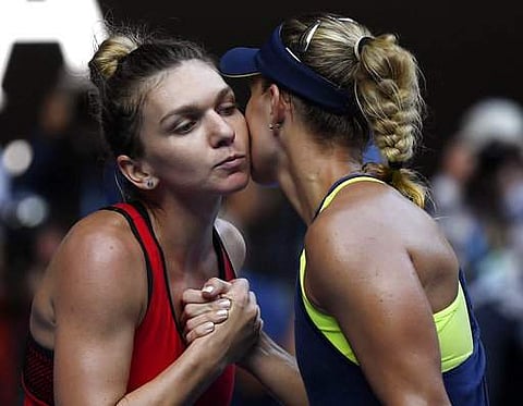 World number one Simona Halep set up an Australian Open final against Caroline Wozniacki after a thrilling 6-3, 4-6, 9-7 battle past former champion Angelique Kerber on Thursday. IN PIC: Halep (left) and Kerber greet each other after the semifinal. (Photo