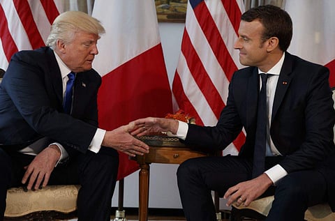 US President Donald Trump shaking hands with French President Emmanuel Macron. (File photo | AP)