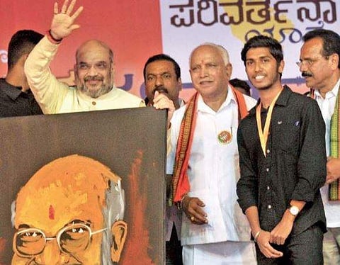 BJP chief Amit Shah greeting party workers, along with party state president  B S Yeddyurappa at BJP Parivarthana Yatra in Mysuru on Thursday | Udayashankar S