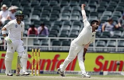 Jasprit Bumrah bowls as South Africa's batsman Dean Elgar looks on during the fourth day of the third cricket test match. | AP