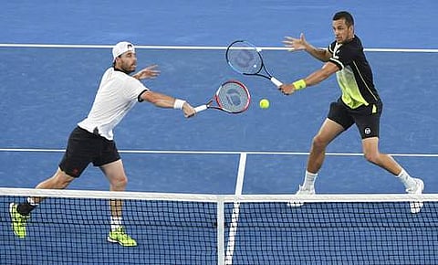 Austria's Oliver Marach, left, and Croatia's Mate Pavic reach for the ball during the men's doubles final. | AP