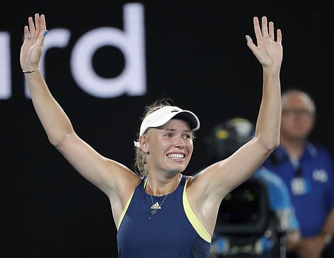Denmark's Caroline Wozniacki celebrates after defeating Romania's Simona Halep in the women's singles final at the Australian Open. (AP)