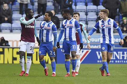 West Ham United's Arthur Masuaku, left, leaves the field after being sent-off during the FA Cup, fourth round match against Wigan at the DW Stadium, Wigan, England. | AP