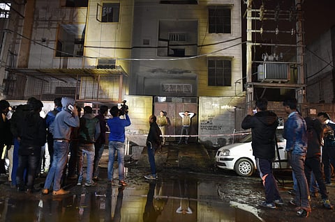 Fire fighters and media outside the two-storey cracker factory which caught fire in north Delhi's Bawana Industrial Area. (File | PTI)