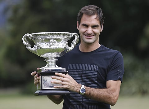 Switzerland's Roger Federer poses with the Norman Brookes Challenge Cup after winning the men's singles final at the Australian Open against Croatia's Marin Cilic in Melbourne. | AP