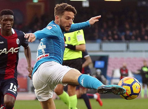 Napoli's Dries Mertens reaches for the ball during the Serie A soccer match between Napoli and Bologna at the San Paolo Stadium in Naples, Italy, Sunday, Jan.28, 2018. | AP