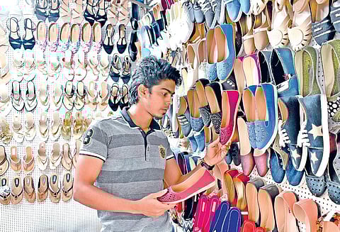 Abdul at his footwear stall in Vijayanagar Market. JITHENDRA M.
