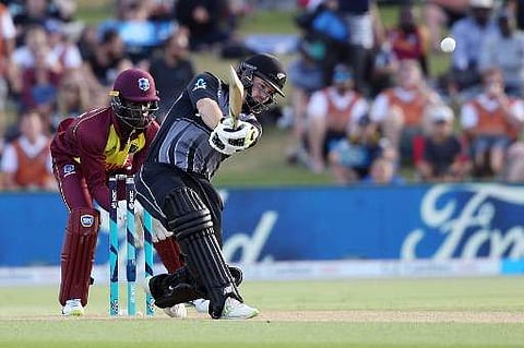 New Zealand's Colin Munro (R) bats as West Indies wicketkeeper Chadwick Walton (L) looks on, during the third T20 between New Zealand and the West Indies at Bay Oval in Mount Maunganui on January 3, 2018. | AFP