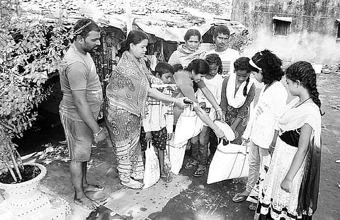 Children collecting food items from a house in Sambalpur on Tuesday | EXPRESS