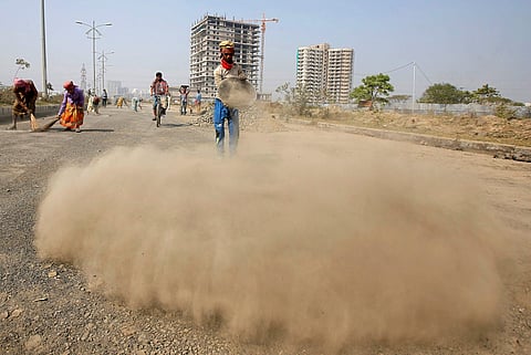 Labourers build a road near the construction site of a residential complex on the outskirts of Kolkata, India, January 29, 2018. (Reuters)