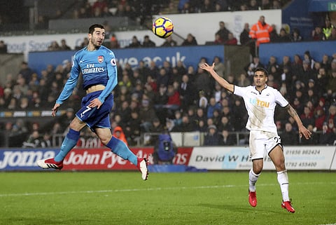 Arsenal's Henrikh Mkhitaryan, left, heads the ball on goal during the English Premier League soccer match between Swansea City and Arsenal at the Liberty Stadium, Swansea. | AP