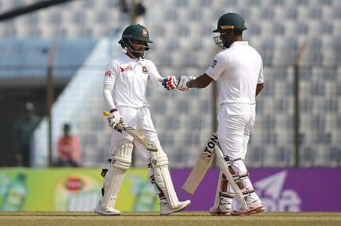 Bangladesh's Mominul Haque, left, celebrates a boundary shot with his teammate Imrul Kayes during the first day of the first test cricket match against Sri Lanka. (Photo | AP)