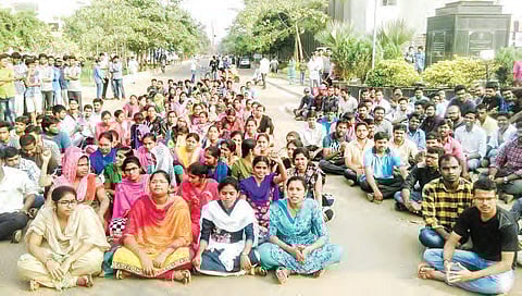 JNTUK students staging a protest in Kakinada on Tuesday demanding action against Prof K Babulu  | Express